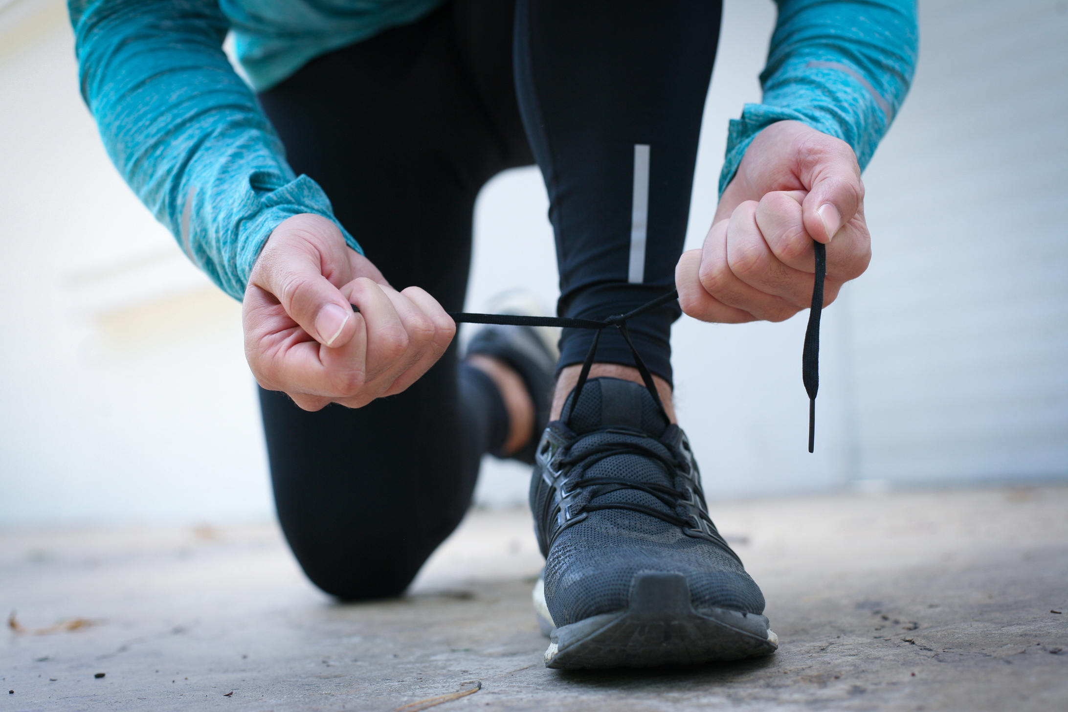Man tying snickers before running.
